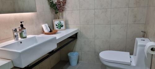 a bathroom with a sink and a toilet at The Robertson Kuala Lumpur by PremierHome 5-6pax in Kuala Lumpur