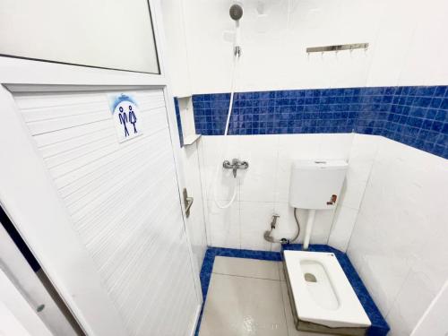 a small bathroom with a toilet and a shower at San Alexander in Bandung