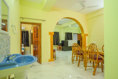 ein Badezimmer mit einem Waschbecken, einem Tisch und Stühlen in der Unterkunft A&A BNB in Port Blair