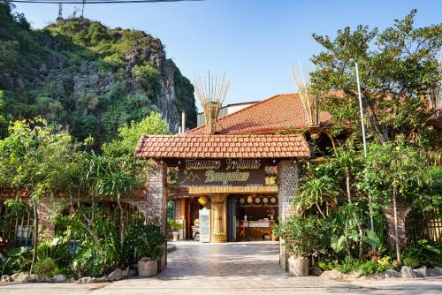a building with a sign that reads country music sandwich at Tam Coc Friends Bungalow Ninh Bình in Ninh Binh