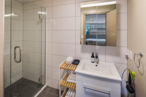 a bathroom with a sink and a shower at Canvas Apartment in Wellington