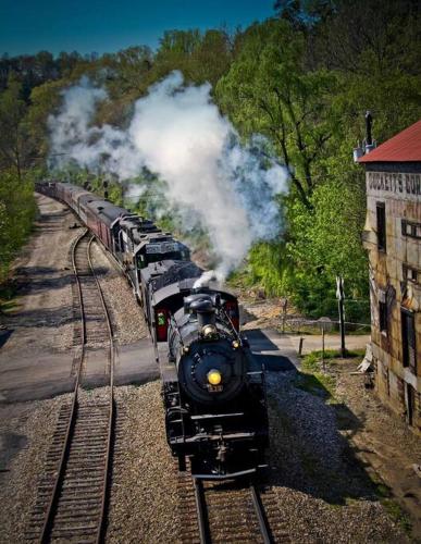 a steam train is coming down the tracks at Bluebirds Nest 10 Min to AVL Biltmore hot tub cont bkfst sparkling water in Asheville
