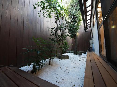 a courtyard with trees and snow on the ground at Osaka MiKa Garden family house direct KIX airport in Osaka