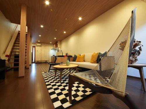 a living room with a couch and a hammock at Osaka MiKa Garden family house direct KIX airport in Osaka
