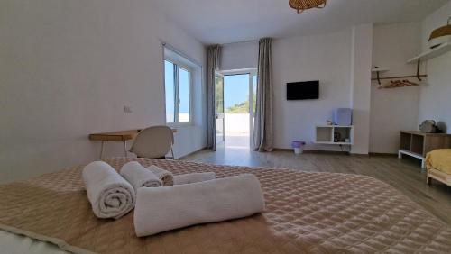 a bedroom with a large bed with towels on it at Le Fronde Vieste in Vieste