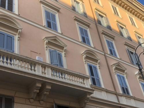 a building with blue windows and a balcony at giolitti central room in Rome