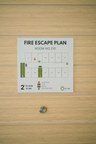 a fire escape plan sign on a door at Circle Inn Ao Nam Mao in Ao Nam Mao