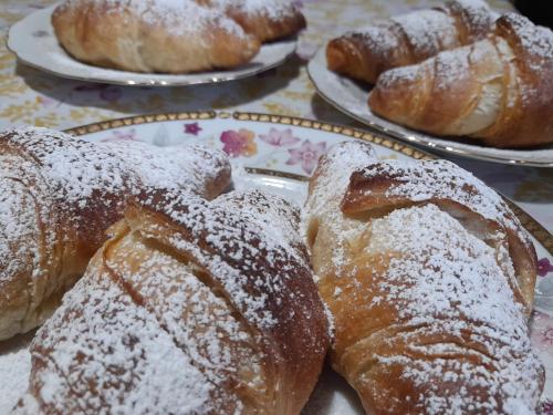 a bunch of pastries on plates on a table at Su Fassoi Cabras in Càbras