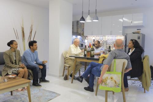 a group of people sitting around a table in a room at Zemilo Hotel Apartment in Addis Ababa