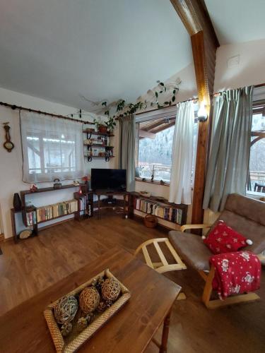 a living room with a couch and a table at Casa Zaharia Azuga in Azuga