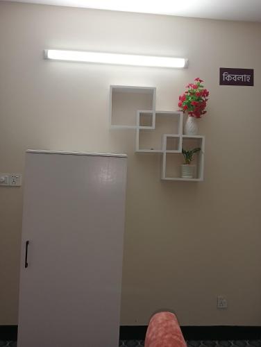 a room with a door and a plant on a wall at Hotel In Need - Near to the US France Italy Saudi Embassy and Airport in Dhaka