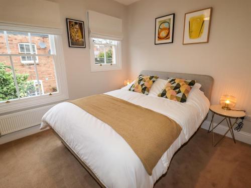a bedroom with a large bed and a window at 4 Albion Place in Chester