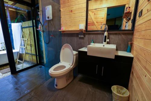 a bathroom with a toilet and a sink at Virgin River @Mae Wan in Chiang Mai