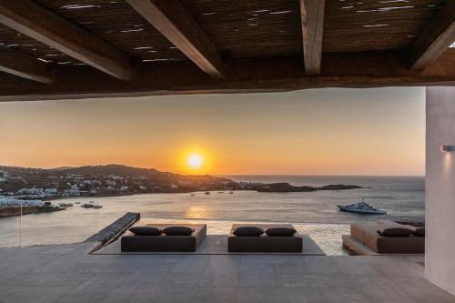 a living room with a view of the ocean at The Skyvilla Mykonos - A Landmark Property with Breathtaking Views of the Psarou bay in Mikonos
