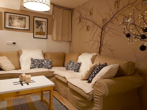 a living room with a couch and a table at InGreen house in Bohinjska Bela