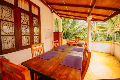 a dining room with a wooden table and chairs at The Blue View Ella in Ella