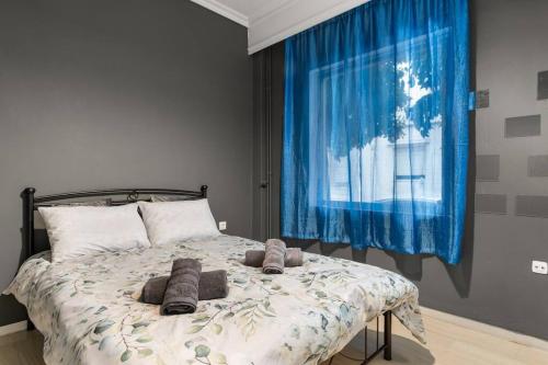 a bedroom with a large bed with pillows on it at Ralia's house 40m from metro station Agia Varvara in Athens