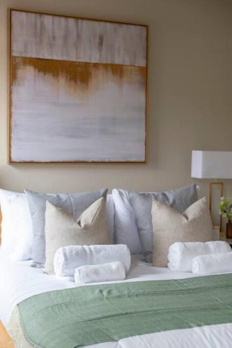 a white bed with pillows on top of it at Elegant 1-BR Retreat in Ilford Centre in Ilford