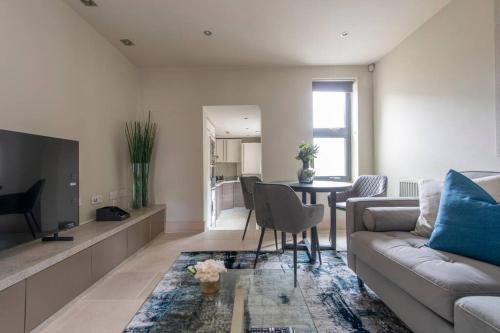 a living room with a couch and a table at Elegant 1-BR Retreat in Ilford Centre in Ilford