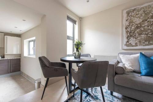 a living room with a table and a couch at Elegant 1-BR Retreat in Ilford Centre in Ilford