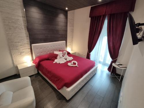 a bedroom with a bed with two towels on it at Royal Rooms in Rome
