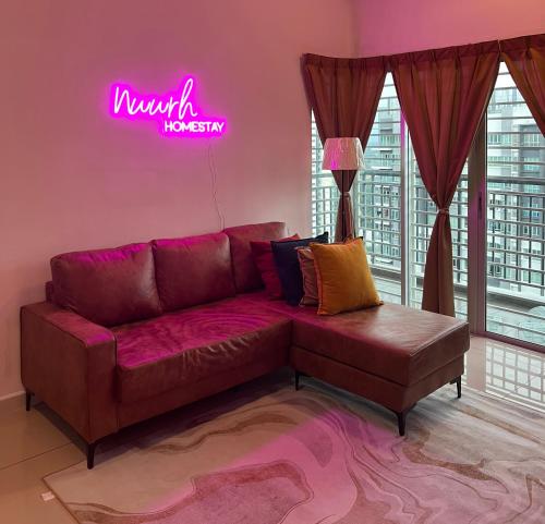 a living room with a couch and a neon sign at Nawwarah Homes @ Southville City (WiFi + NETFLIX) in Kajang