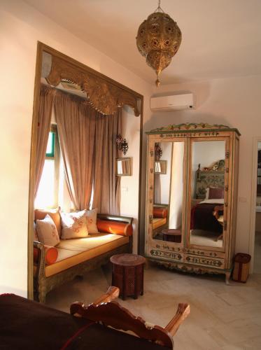 a living room with a mirror and a couch at El Patio Courtyard House in Tunis