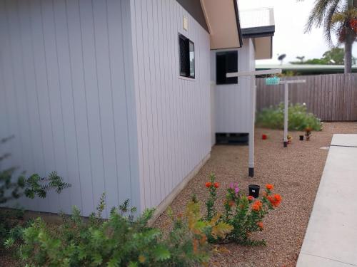 a garden with flowers next to a building at The Dugongs' Rest in Horn