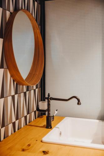 a bathroom with a sink and a mirror at City Glamping by ONE66 Hotel in Ljubljana
