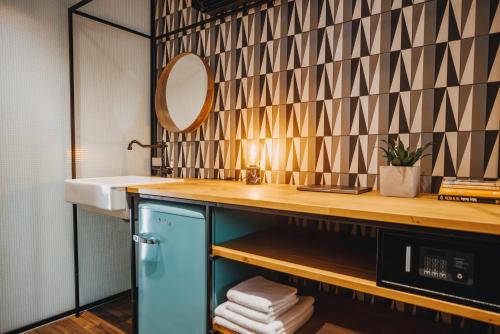 a bathroom with a sink and a mirror at City Glamping by ONE66 Hotel in Ljubljana