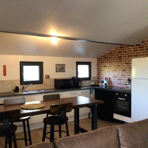 a kitchen with a table and a counter top at Les berges du Seudo in Labastide-de-Lévis