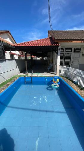 una piscina blu con un giocattolo in una casa di Homestay D'Putra Bertam a Kepala Batas