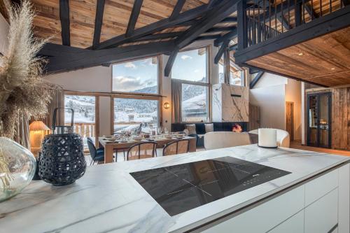 a kitchen and dining room with a table and chairs at Les Chalets de La Clusaz - Appartement le Renne in La Clusaz