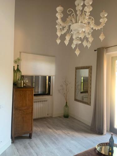 a living room with a chandelier and a wooden floor at Borgo Crispiero in Crispiero