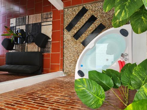 a room with a jacuzzi in a brick wall at Mi Amor Vacation Home - A Private Big House with 2 separate Bedrooms, Central Location, Fully Furnished, Only 5 Minutes To The Beach in Phu Quoc