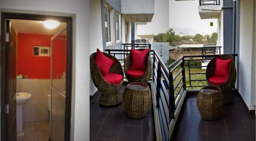 un balcón con sillas y almohadas rojas. en Rental Furnished Apartment{ Two Bed Room }, en Kisumu