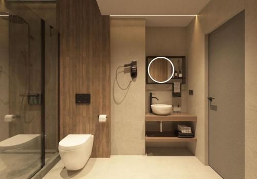 a bathroom with a toilet and a sink and a mirror at FULL HOUSE apart hotel in Rivne
