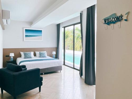 a bedroom with a bed and a view of a pool at Sand Dance Hotel in Prachuap Khiri Khan