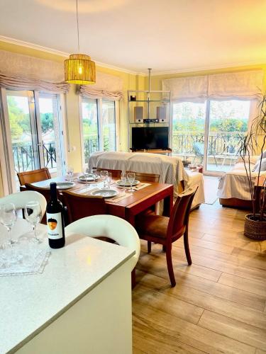 a dining room with a table with wine glasses on it at SeaHomes Vacations - NAUTIC MARITIME Apt in Blanes
