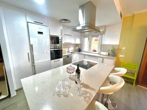 a kitchen with a counter with a bottle of wine on it at SeaHomes Vacations - NAUTIC MARITIME Apt in Blanes