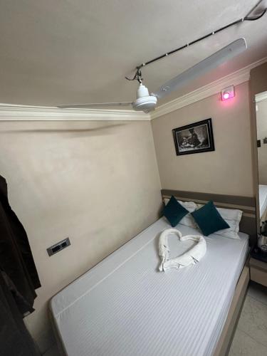 a bedroom with a bed with a heart shapedvisorvisor at Hotel Vinayak in Kharagpur