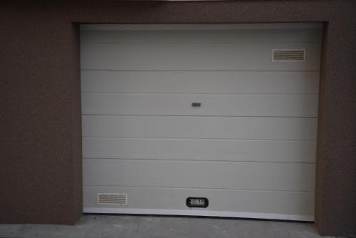 a white garage door in a box at SM apartman in Bijeljina