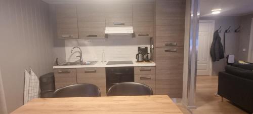 a kitchen with a table and chairs in a room at Micke o Ritas stuga in Björkliden