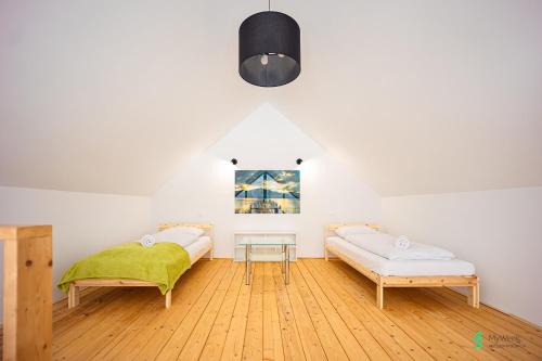 a living room with two beds and a table at Dom w Starej Morawie, MyWeekpl in #N/A