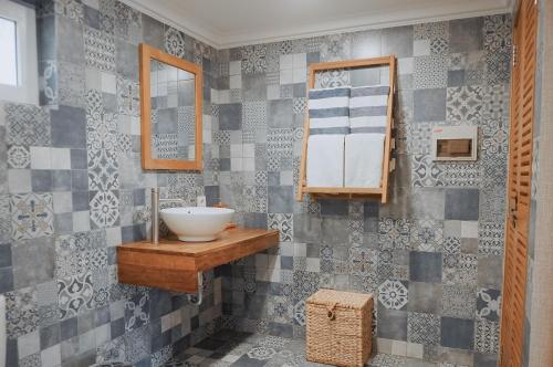 a bathroom with a sink and a mirror at Coconut Lodge Resort in Jepara