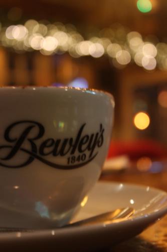 a coffee cup sitting on a plate on a table at Tralee Benners Hotel in Tralee