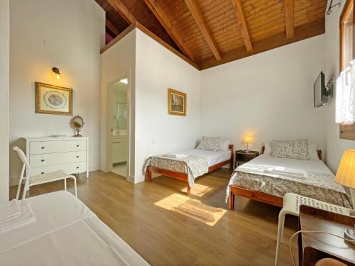 a bedroom with two beds and a dresser in it at Casa Orgi in Lizaso