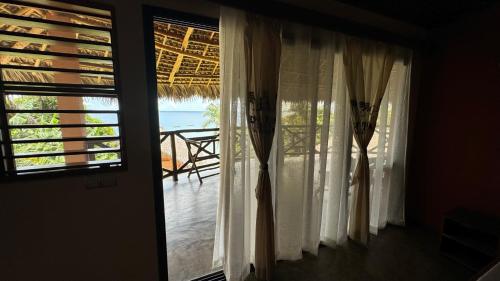 a room with a window with a view of the ocean at VERONIKA Resort Nosy Komba in Nosy Komba
