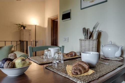 einen Tisch mit Brot und eine Schüssel Essen darauf in der Unterkunft Borgo Al Cerro in Casole dʼElsa