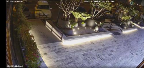 an overhead view of a patio with plants and lights at Riggae Tower Hotel in Kuwait